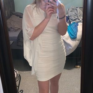 White dress with gold sparkles one shoulder.